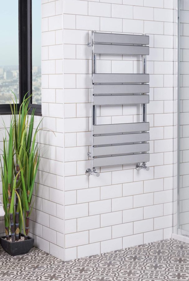 A metallic heated towel rack in a modern renovated bathroom